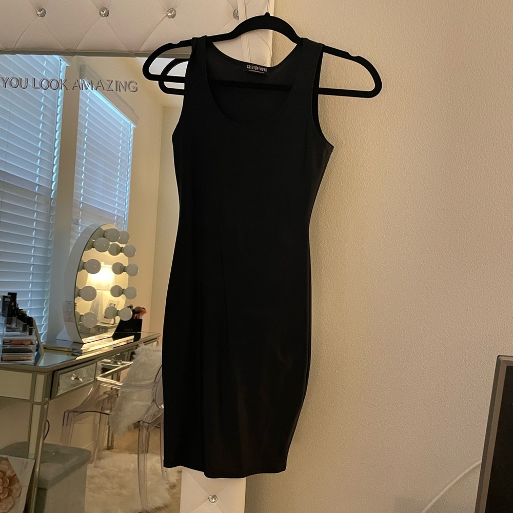 MAJOR CLOSET SALE. MORE ITEMS TO COME. 100% Lycra black mini dress. Very tight.